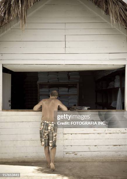 man at the beach shack. - shack stock pictures, royalty-free photos & images