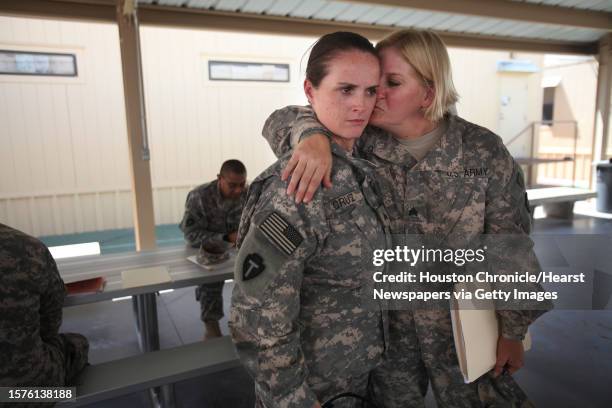 Sgt. Shawn Cruz, of Houston, is embraced by Sgt. Tonya Callaway of Houston, wait their turn for the hearing test as 72nd's IBCT Alpha 72nd Special...
