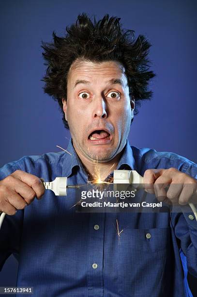 shocked man on blue - sparks - electrical shock stock pictures, royalty-free photos & images