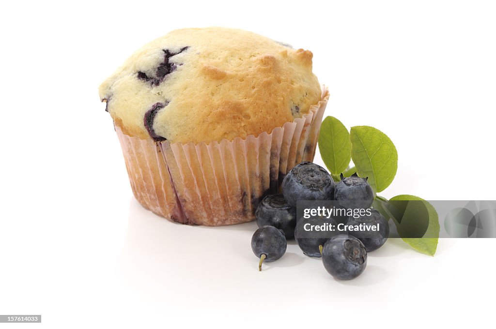 Blueberry Muffin and fresh blueberries, isolated on white