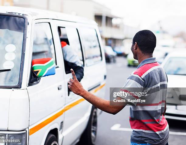 south african street scene with man signalling a taxi - taxi van stockfoto's en -beelden