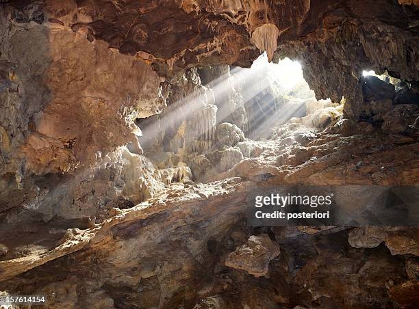 interior of a rocky cave illuminated by sunlight - 洞窟 個照片及圖片檔