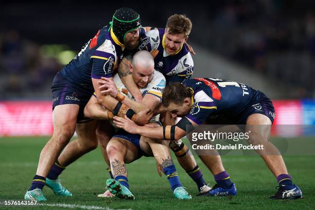 Clint Gutherson of the Eels is tackled by Tepai Moeroa of the Storm , Cameron Munster of the Storm and Alec MacDonald of the Storm during the round...