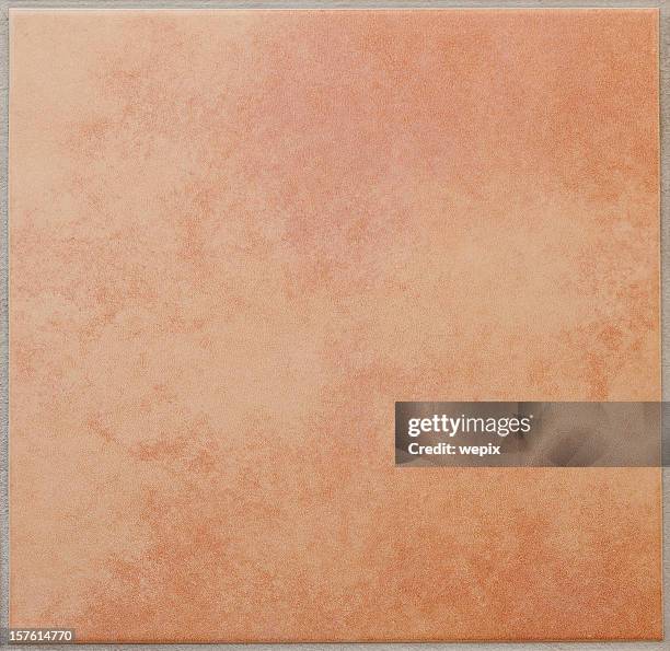 single apricot colored ceramic tile textured full frame - ceramic stockfoto's en -beelden
