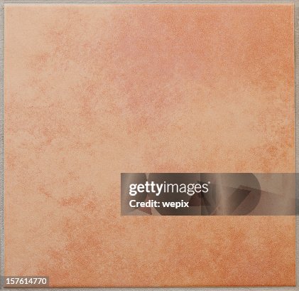 Single apricot colored ceramic tile textured full frame Single apricot colored ceramic tile textured full frame