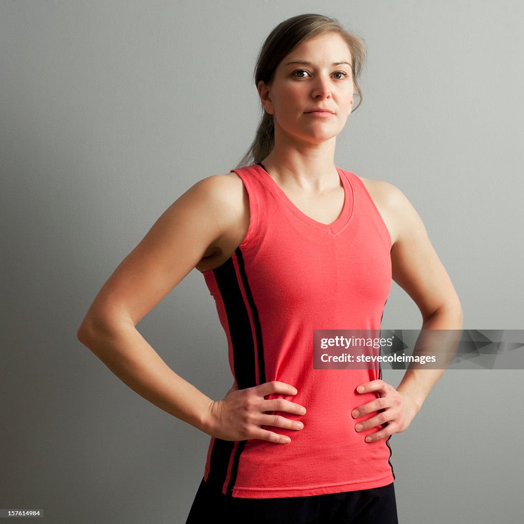 Young Fit Woman With Arms Akimbo