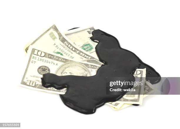 bad money with oil - schmutziges geld - waste wealth stock pictures, royalty-free photos & images