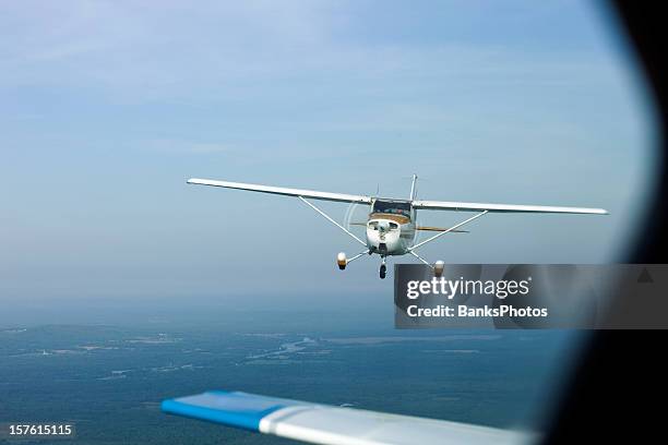 airplane-to-airplane shot of a classic plane closing in - propellervliegtuig stockfoto's en -beelden