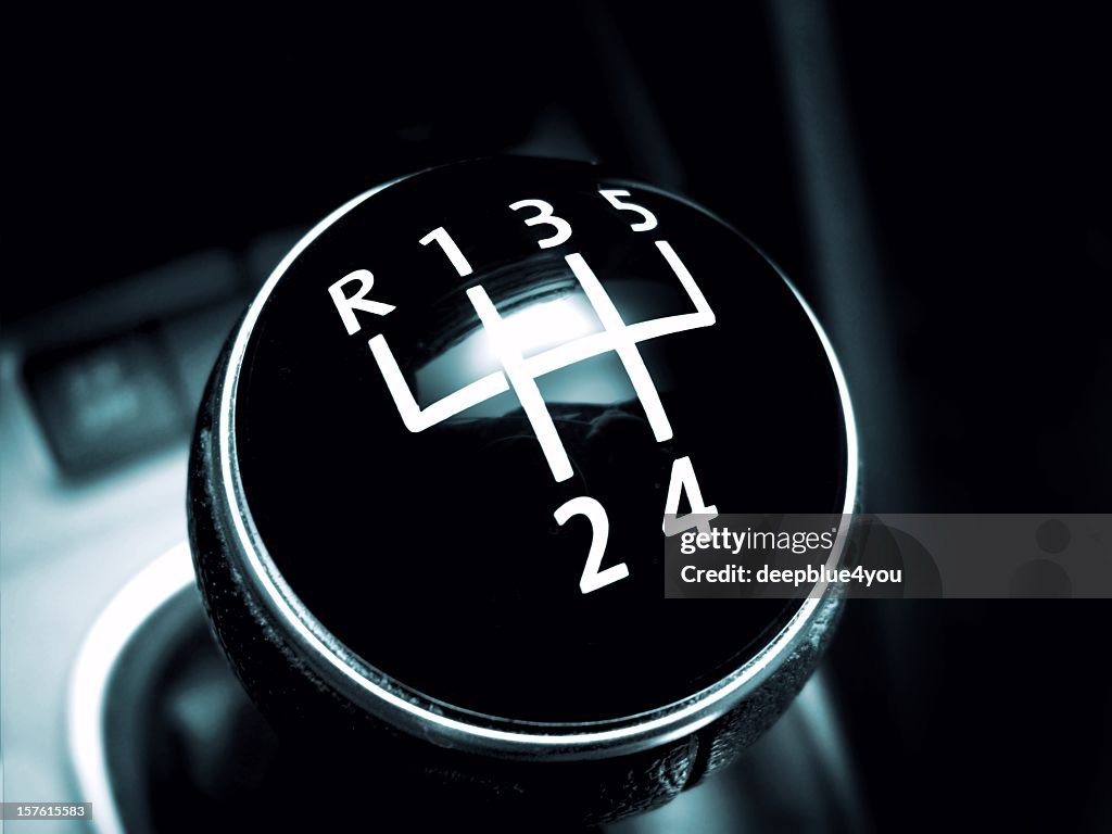 Modern gearstick of a sport car on black
