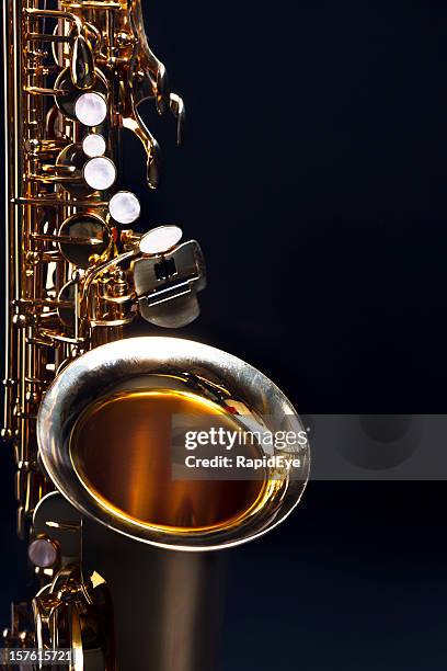 moody blues: saxophone with dark blue copy space - sax stockfoto's en -beelden