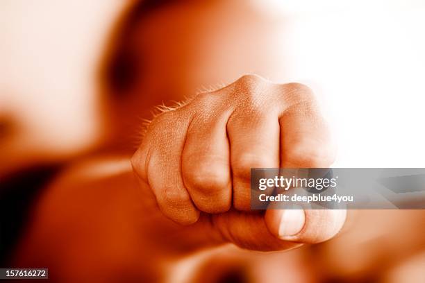 violence  - man's fist comes to meet - punsch stock pictures, royalty-free photos & images