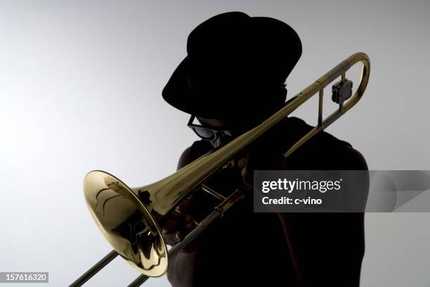 silhouette eines trombonist - of jazz musicians stock-fotos und bilder