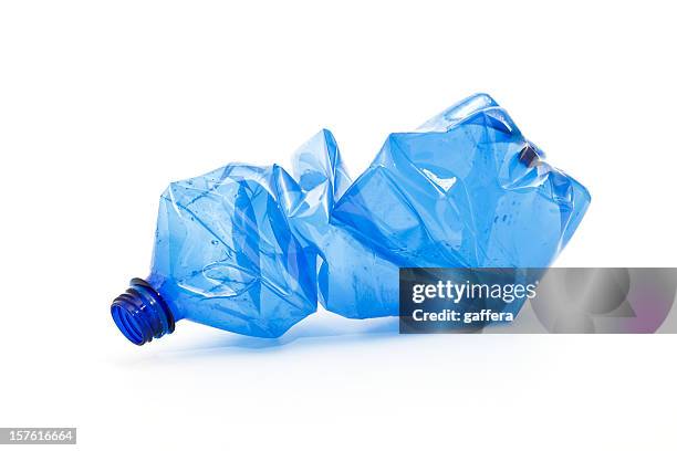 crushed blue plastic bottle - garbage stockfoto's en -beelden