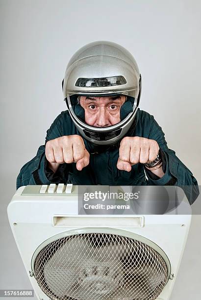 eccentric biker in front of fan. - moto humour stock pictures, royalty-free photos & images