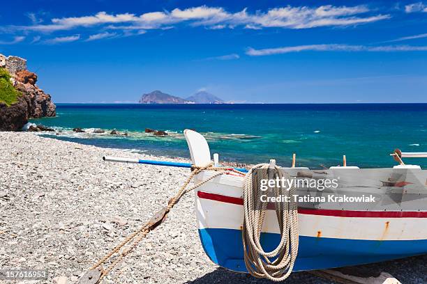 a boat on the shore of the mediterranean - aeolian islands stock pictures, royalty-free photos & images