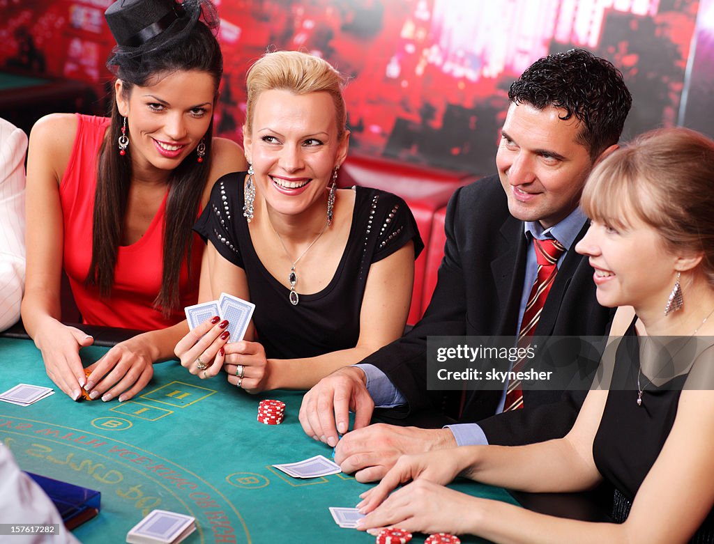 People playing at the Blackjack table in casino.