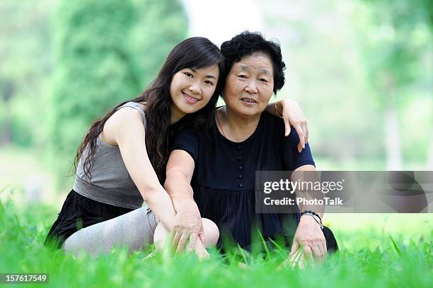 two generation - xlarge - young woman and senior lady in a park stock pictures, royalty-free photos & images