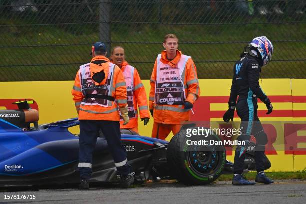 Logan Sargeant of United States and Williams walks from his car after stopping on track during practice ahead of the F1 Grand Prix of Belgium at...
