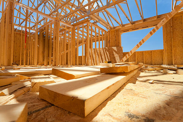 Timber in building construction showing wooden logs and timber boards