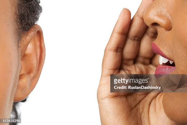 whispering into my ear. - gossip stock pictures, royalty-free photos & images