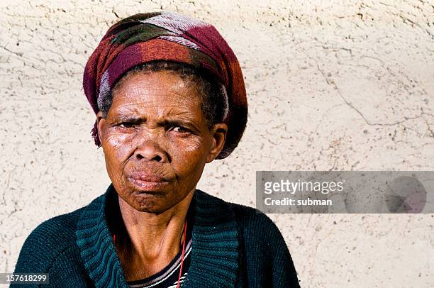 old xhosa woman infront of house - xhosa culture stock pictures, royalty-free photos & images