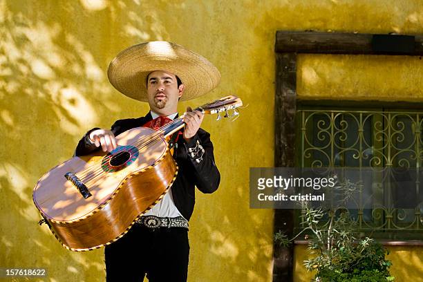 mariachi playing guitar - mariachi band stock pictures, royalty-free photos & images