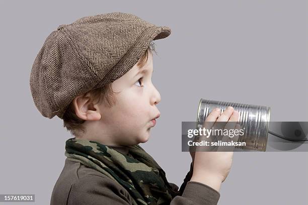 linda little boy comunicarse por teléfono de lata - tin can phone fotografías e imágenes de stock