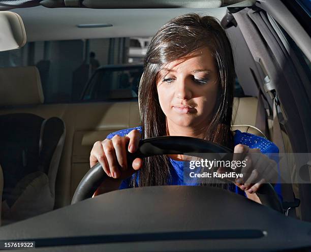 eyelids drooping, this woman driver is sleepy or very bored - car blinker stock pictures, royalty-free photos & images