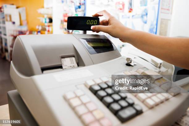 woman's hand checks readout on cash register - cash register stock pictures, royalty-free photos & images