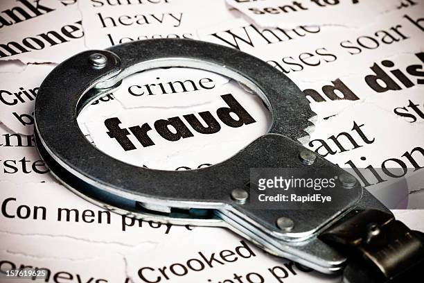 handcuffs over newspaper with the word fraud - ponzi scheme stockfoto's en -beelden