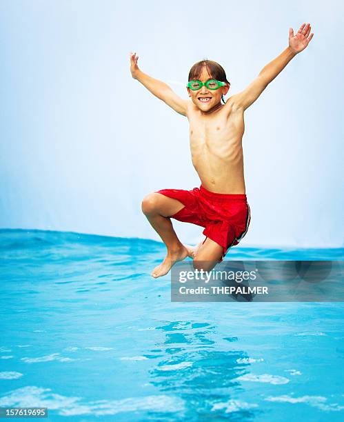 kid having a good time in the pool - jumping in pool stock pictures, royalty-free photos & images