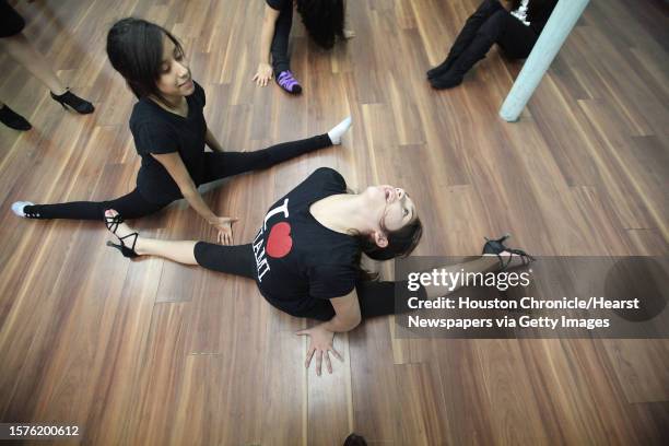 Jasmine Rodriguez stretches before reKreation Dance Company rehearsal for the 7th AnnualTexas Salsa Congress on Sunday, Feb. 27 in Houston....