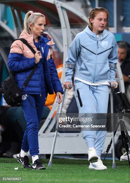 Keira Walsh of England returns to the bench with crutches after leaving the pitch with an injury during the FIFA Women's World Cup Australia & New...