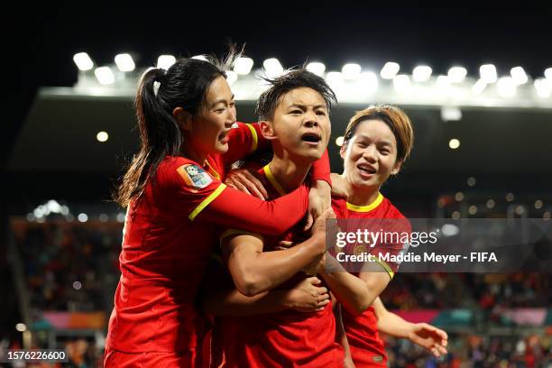 Wang Shuang of China PR celebrates with teammates Yang Lina and Zhang Xin after scoring her team's first goal during the FIFA Women's World Cup...