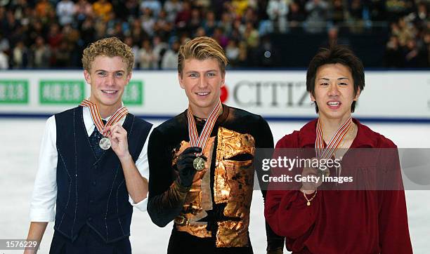 Silver medallist Timothy Goebel of USA, gold medallist Alexei Yagudin of Russia and bronze medallist Takeshi Honda of Japan pose on the podium after...