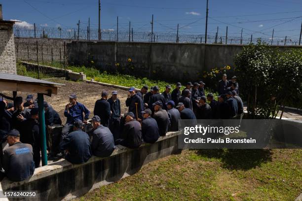 Russian POWs are seen smoking outside living in a prisoner of war detention camp on August 3, 2023 in the Lviv region, Ukraine. Hundreds of captured...