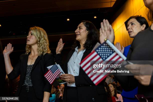 Immigrants take the Oath of Allegiance at a naturalization ceremony at Grand Teton National Park August 4, 2023 in Moose, Wyoming. U.S. Citizenship...