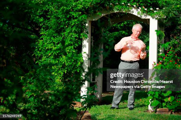 Donald Burger holds a mason jar which is used to catching fireflies on Thursday, June 23 in Houston.