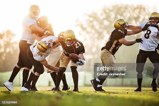 college football - catch and tackle. - tackling stock pictures, royalty-free photos & images