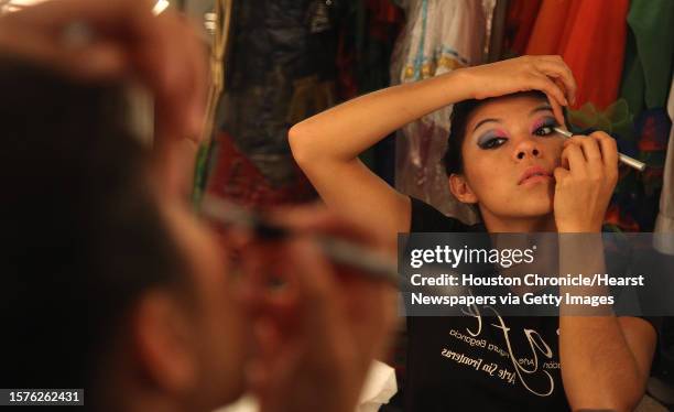 Atalia Castro, a performer for the Columbian dance group CAFE, applies stage make-up right before the "Un Canto por Colombia" performance at the...