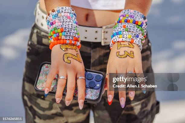 Inglewood, CA Taylor Swift fan Emma Sadeghi, of Glendale, shows her friendship bracelets as she arrives at the emporarily renamed "Speak Now/Taylor's...