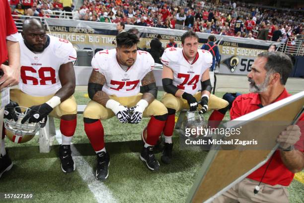 Offensive Line Coach Mike Solari of the San Francisco 49ers talks with Leonard Davis, Mike Iupati and Joe Staley during the game against the St....