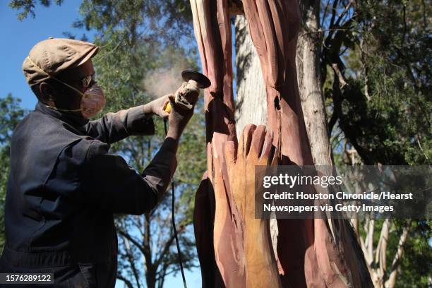 "The hands represent the people who came before me, and they are releasing the dove of freedom" says sculptor Earl Jones as he files shape into his...