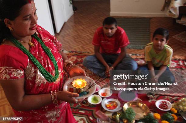 Lachi Kheral walks around in a circle with a candle light to protect people inside circle during the Bhai Tika as Kheral celebrates Deepawali in...
