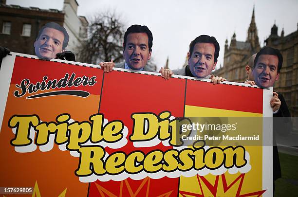 Members of the UNISON union wear masks depicting Chancellor George Osborne as they protest against budget cuts near Parliament on December 5, 2012 in...