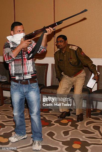 Volunteers pose as terrorists during a mock security drill as part of Delhi Emergency Management Exercise at Crown Plaza Hotel in New Delhi on...