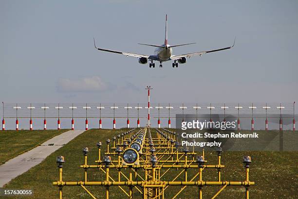 a plane approaching the runway - stephan rebernik stock-fotos und bilder