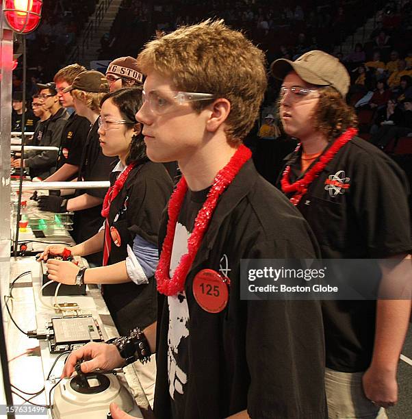 Mentor Brendan Holly, right, a Northeastern University student, watches his drive team Yoonjeong Cha, Brookline High School, and Chapin Cutler,...
