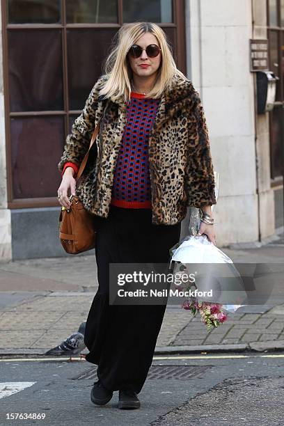 Fearne Cotton is pictured carrying flowers on her last day at Radio 1 before her maternity leave starts on December 5, 2012 in London, England.