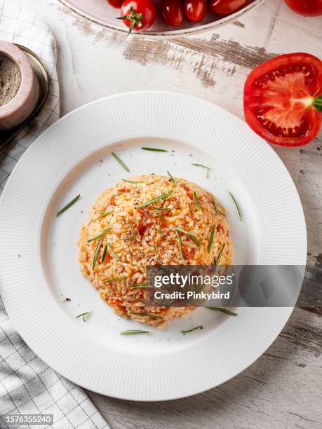 tomato pilaf, traditional delicious turkish food; rice pilaf with tomatoes (turkish name; domatesli pirinc pilavi), rice with tomato sauce - middle eastern food stock pictures, royalty-free photos & images